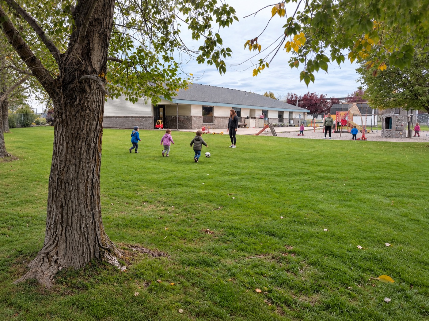 Kids running and playing on the grass in our backyard
